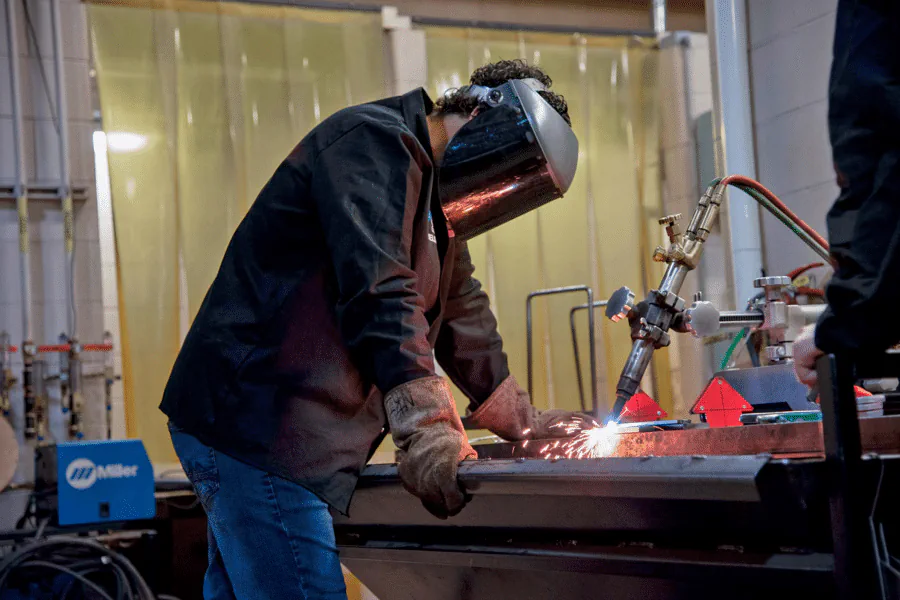 A welder working on a metal fabrication
